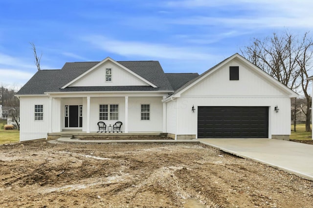 view of front of house with an attached garage, driveway, a porch, and roof with shingles