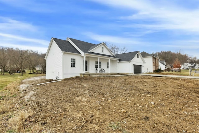 view of front facade with a garage and covered porch