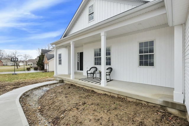 entrance to property featuring a porch and board and batten siding