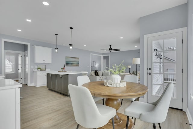 dining room with light wood-type flooring, baseboards, a ceiling fan, and recessed lighting