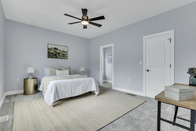 bedroom featuring ceiling fan, carpet flooring, visible vents, and baseboards