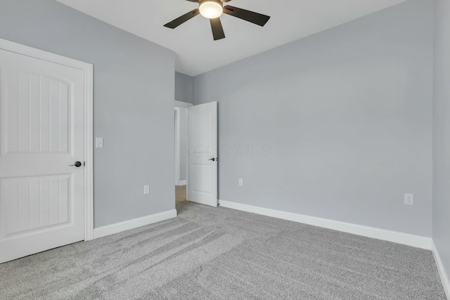 unfurnished bedroom with a ceiling fan, carpet flooring, and baseboards