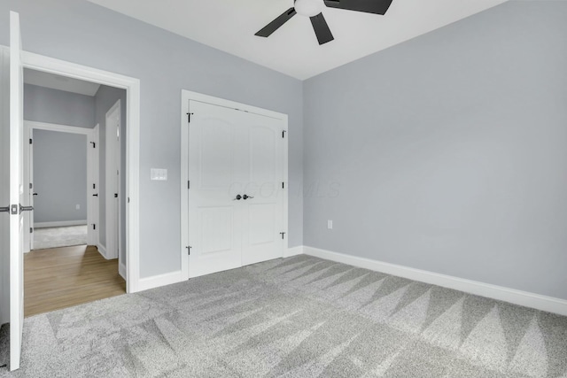 unfurnished bedroom featuring ceiling fan, a closet, baseboards, and carpet flooring