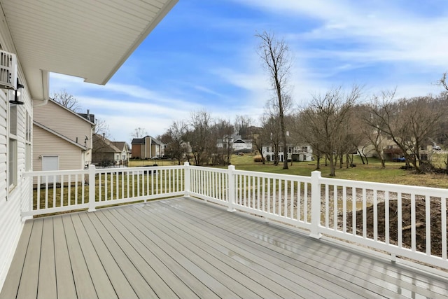 deck with a residential view and a lawn