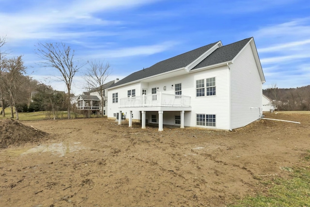 rear view of property featuring a wooden deck