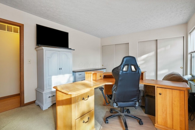 office area featuring visible vents, a textured ceiling, and baseboards