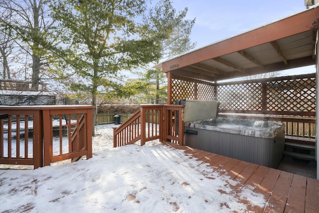 snow covered deck featuring fence and a hot tub