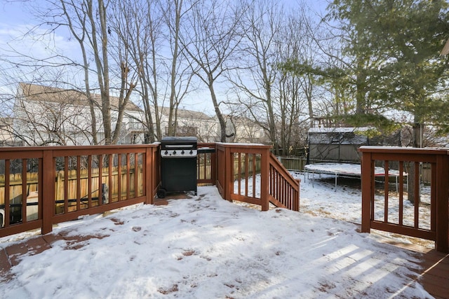 snow covered deck featuring a trampoline and grilling area