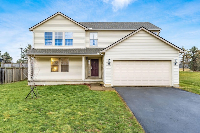 traditional-style home with covered porch, a garage, fence, driveway, and a front lawn