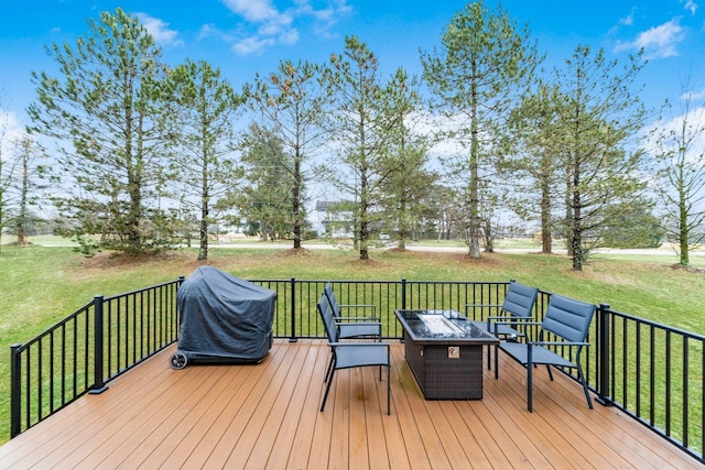 wooden terrace featuring a fire pit, area for grilling, and a yard