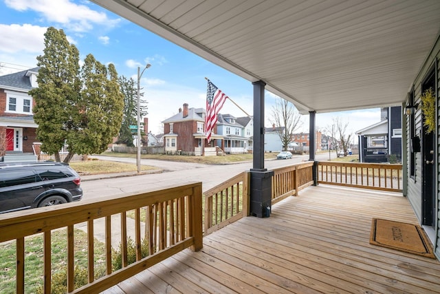 wooden deck with a porch and a residential view