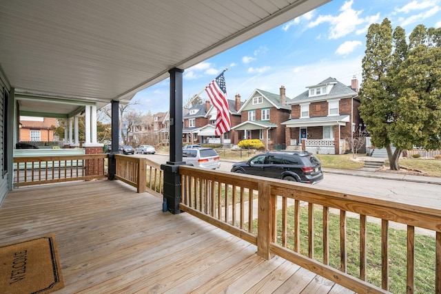 wooden deck with a residential view and a porch