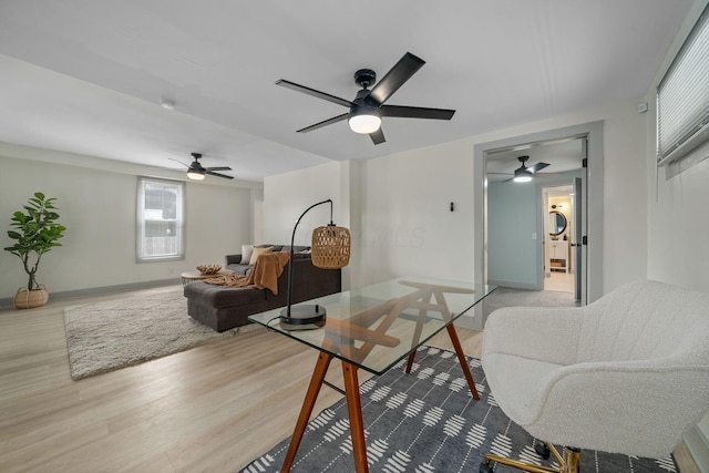 living room with light wood finished floors and baseboards