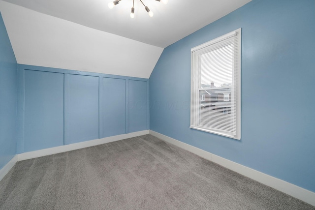 additional living space with carpet floors, vaulted ceiling, and baseboards