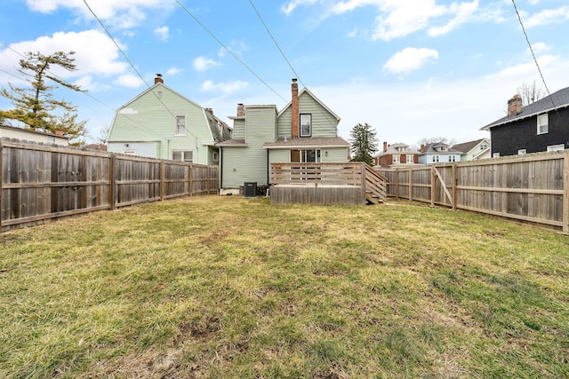 view of yard featuring cooling unit, a fenced backyard, and a wooden deck