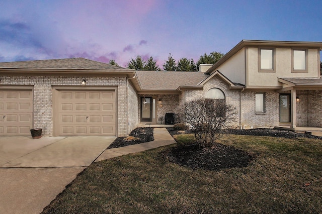 view of front of property with a garage, driveway, roof with shingles, and brick siding