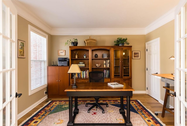 office space with crown molding, baseboards, wood finished floors, and french doors