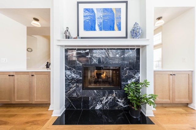 interior details featuring a fireplace and wood finished floors