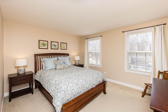 bedroom featuring baseboards and light colored carpet