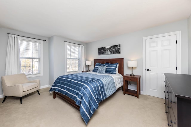 bedroom featuring baseboards and light colored carpet