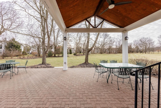 view of patio with a ceiling fan, outdoor dining area, and a gazebo