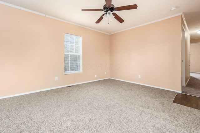 unfurnished room featuring carpet, baseboards, and crown molding