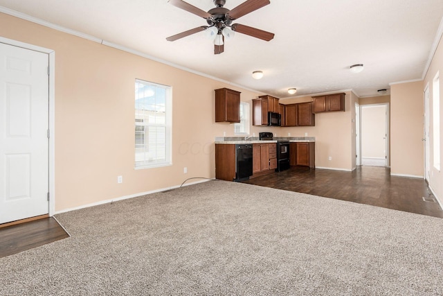 kitchen featuring black appliances, ornamental molding, light countertops, and dark wood finished floors