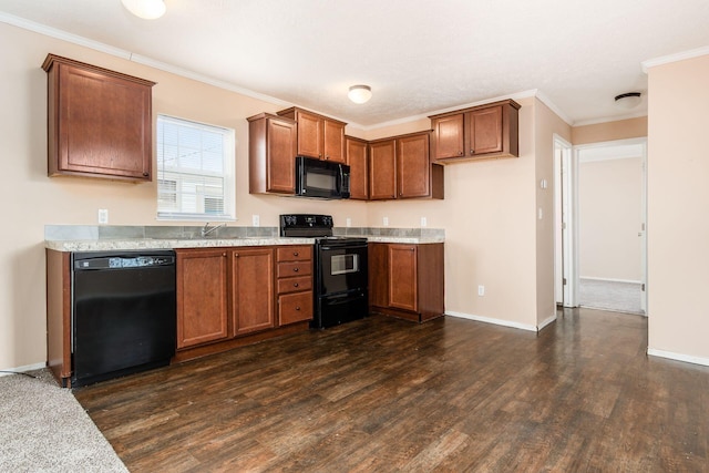 kitchen with brown cabinetry, a sink, dark wood finished floors, and black appliances