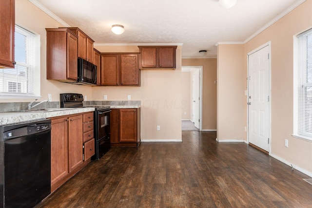 kitchen with a sink, light countertops, ornamental molding, black appliances, and brown cabinetry