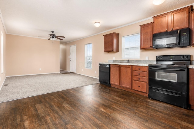 kitchen with open floor plan, dark wood-type flooring, light countertops, crown molding, and black appliances