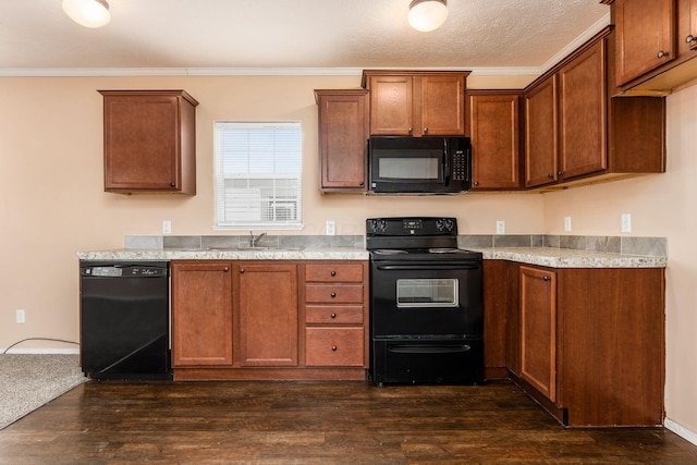 kitchen with black appliances, crown molding, light countertops, and dark wood-style flooring