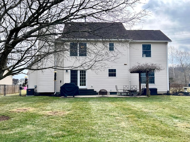 back of property with entry steps, fence, a yard, a patio area, and central AC