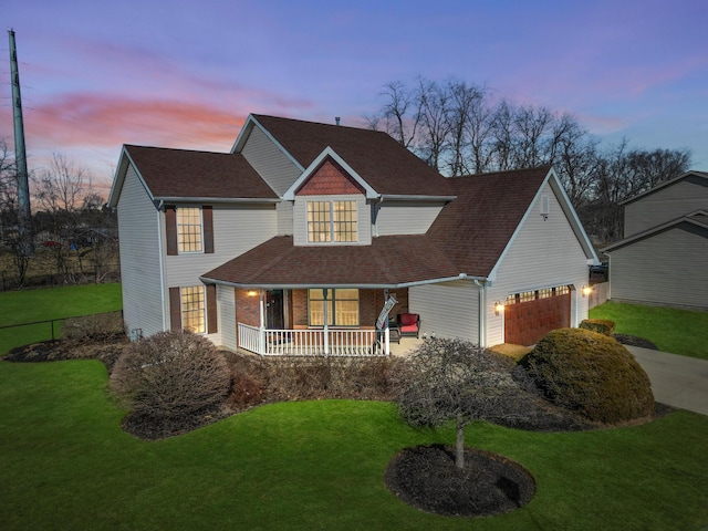 view of front of property with a garage, roof with shingles, a porch, and a front lawn