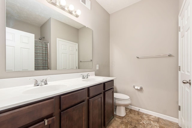 full bathroom with toilet, a sink, visible vents, and baseboards