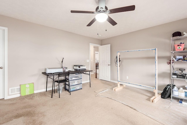 home office featuring a ceiling fan, carpet flooring, visible vents, and baseboards