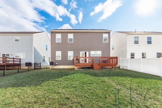 rear view of property featuring a yard, a fenced backyard, and a wooden deck