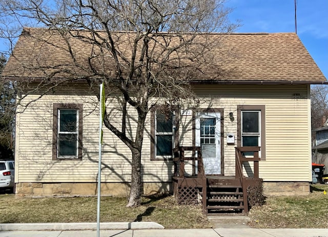 view of front of home with a shingled roof