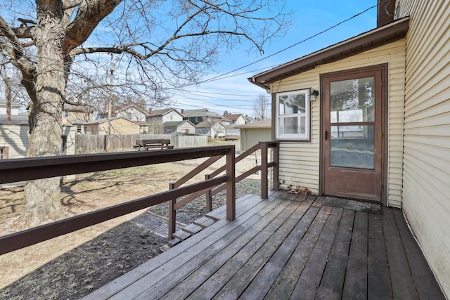 wooden deck featuring a residential view and fence