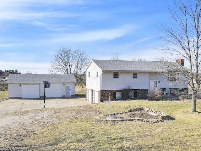 exterior space with a detached garage, an outdoor structure, and a yard