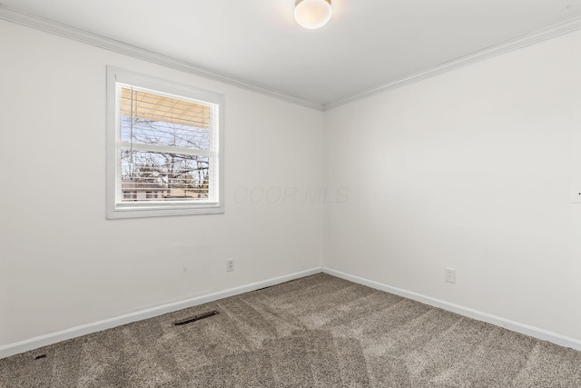 carpeted empty room with visible vents, baseboards, and crown molding