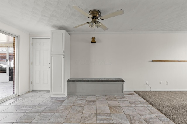 empty room featuring crown molding, baseboards, and ceiling fan