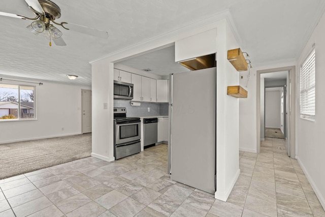 kitchen with ceiling fan, white cabinetry, light countertops, appliances with stainless steel finishes, and tasteful backsplash