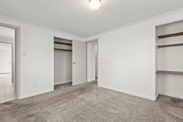 unfurnished bedroom with carpet, crown molding, and baseboards