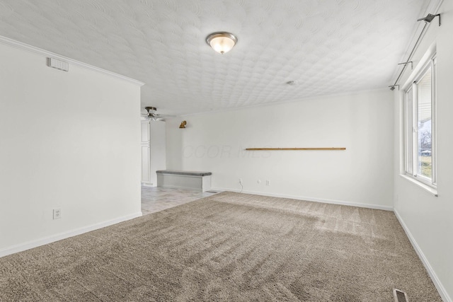 unfurnished living room featuring visible vents, a ceiling fan, carpet flooring, a textured ceiling, and baseboards