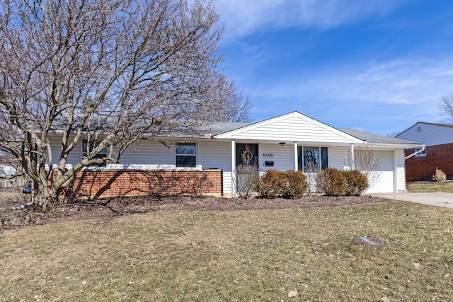 ranch-style home with a garage, a front yard, and concrete driveway