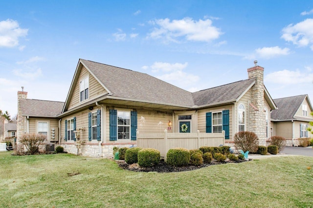 view of home's exterior with roof with shingles, a yard, a chimney, and fence