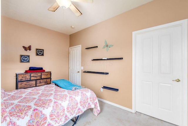 carpeted bedroom featuring a ceiling fan and baseboards