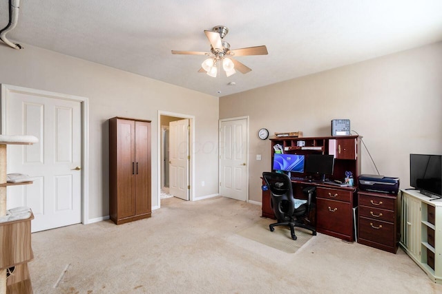 office area with light carpet, baseboards, and a ceiling fan