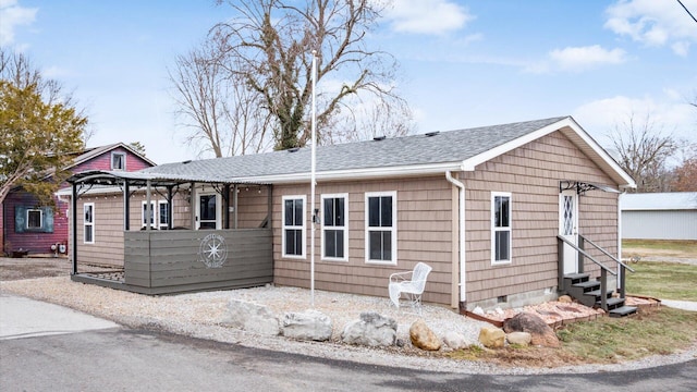 single story home featuring entry steps, a shingled roof, and crawl space