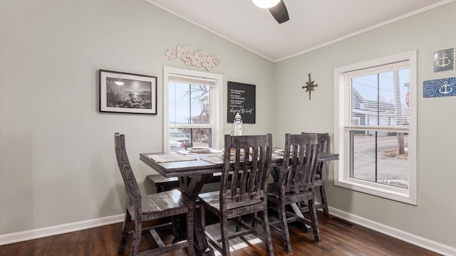 dining space featuring visible vents, ceiling fan, vaulted ceiling, wood finished floors, and baseboards